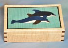 The Dolphin Box  Our family friend, Karen, loves Dolphins.  She is a diver, a sailor, and has decorated her home with a Dolphin Theme.  So I made this box for her as a Christmas present.  I used dyed veneers in white, black and dark blue.  The box itself is curly maple.  By the way, she is also a photographer.  She did my daughter's wedding and she also took many of the photos you see in this "Box Gallery".