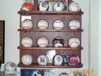 Baseball Display  Over the years I have accumulated a bunch of autographed baseballs (Tony Gwynn, Hank Aaron, Bill Mazeroski, Cal Ripken Jr., etc.). I wanted something neat and simple to display them, so I made this stand from rosewood. The shelves are attached with sliding dovetails, and each shelf has four holes for the plastic baseball covers.