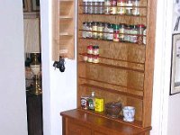 Mom's Spice Table  Mom wanted a "free standing spice rack" that would fit next to the refrigerator. Hmm... That's going to be a challenge. This is what we came up with! Made from cherry, the table is 8 1/4" deep and has two drawers for the measuring spoons